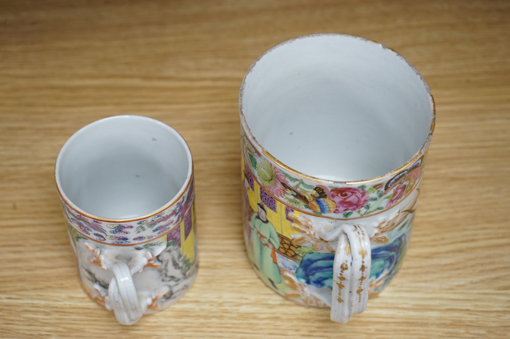 A Chinese Export Canton Famille rose mug and another smaller, Daoguang period (1821-50), tallest 12cm